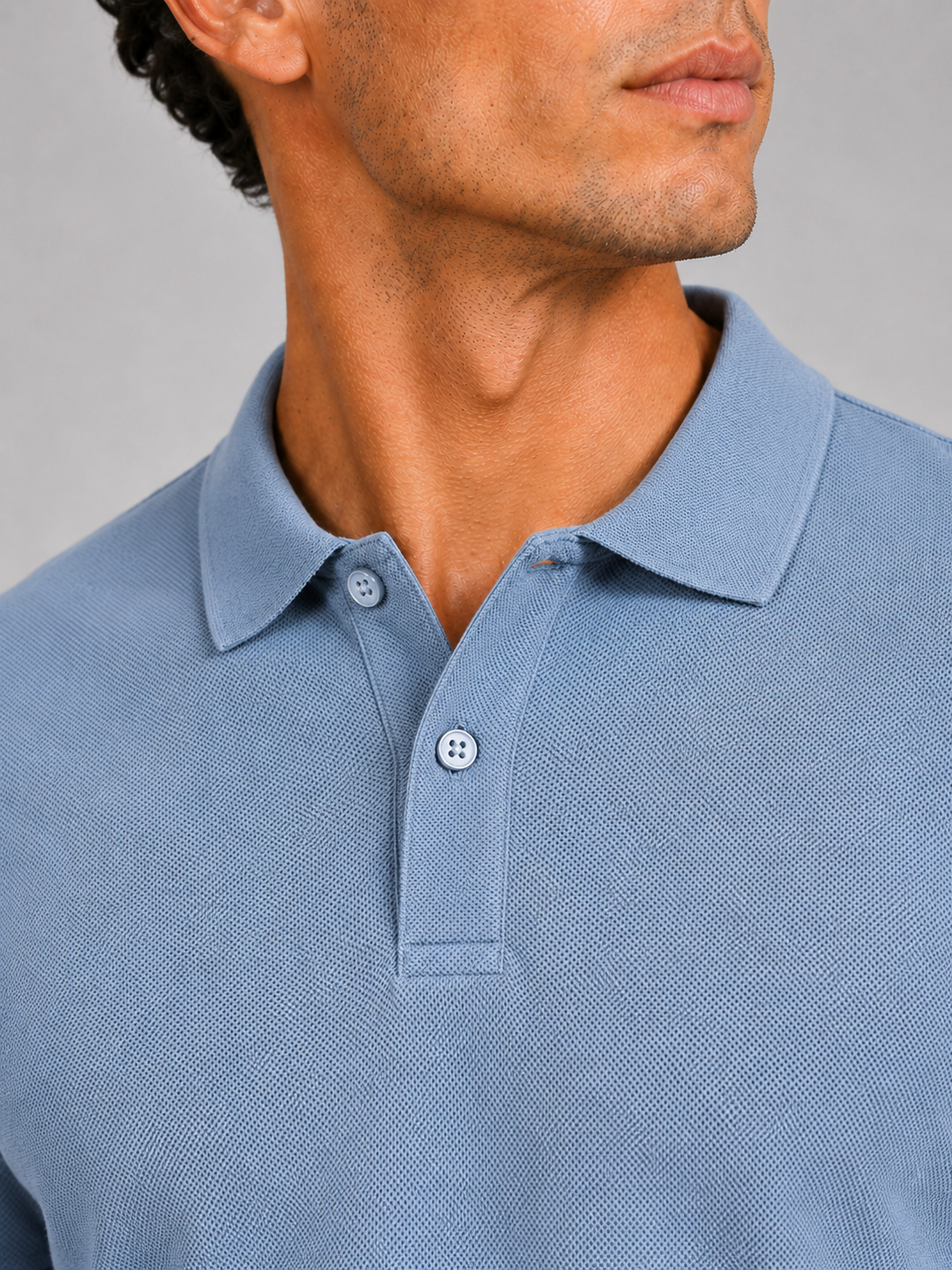 Close up of light blue polo shirt showing smooth silk touch fabric and refined collar detail
