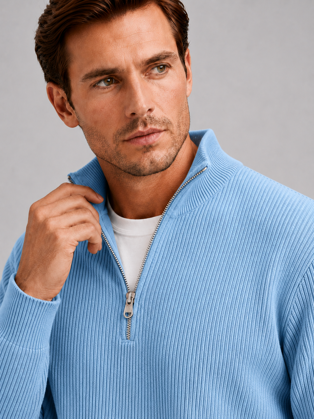 Close up of light blue quarter zip sweater showing ribbed knit texture, stand collar, and zipper detail