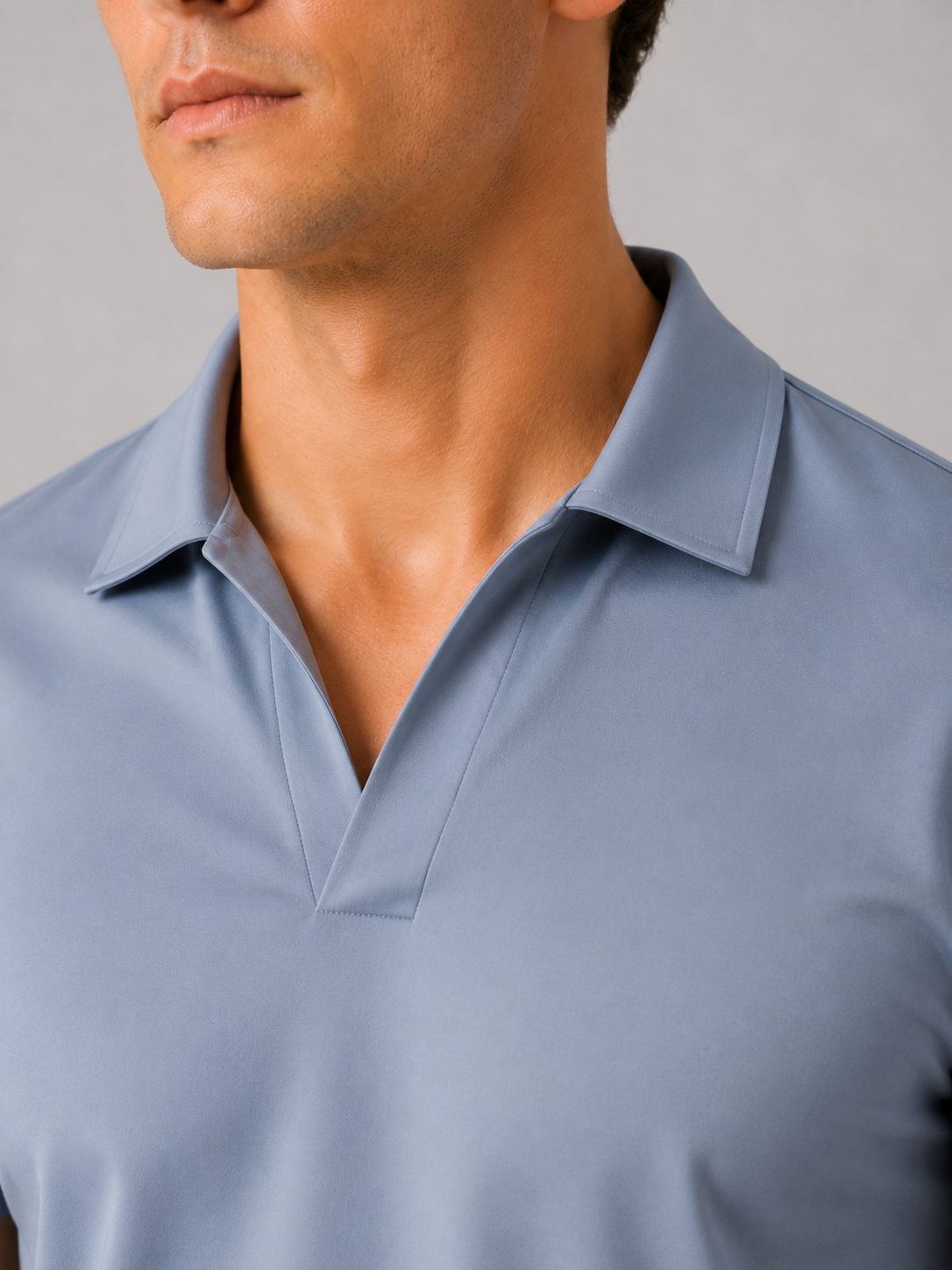 Close up of light blue polo shirt showing smooth silky fabric and refined collar detail
