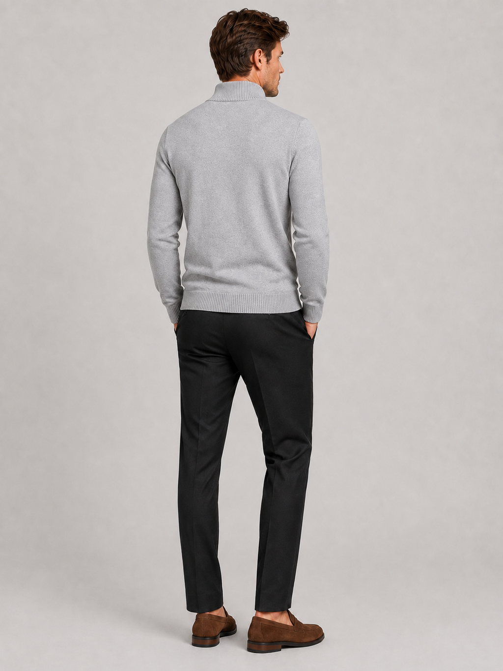 Back view of a man wearing a light gray full zip knit sweater showing the slim fit, long sleeves, and clean knit construction