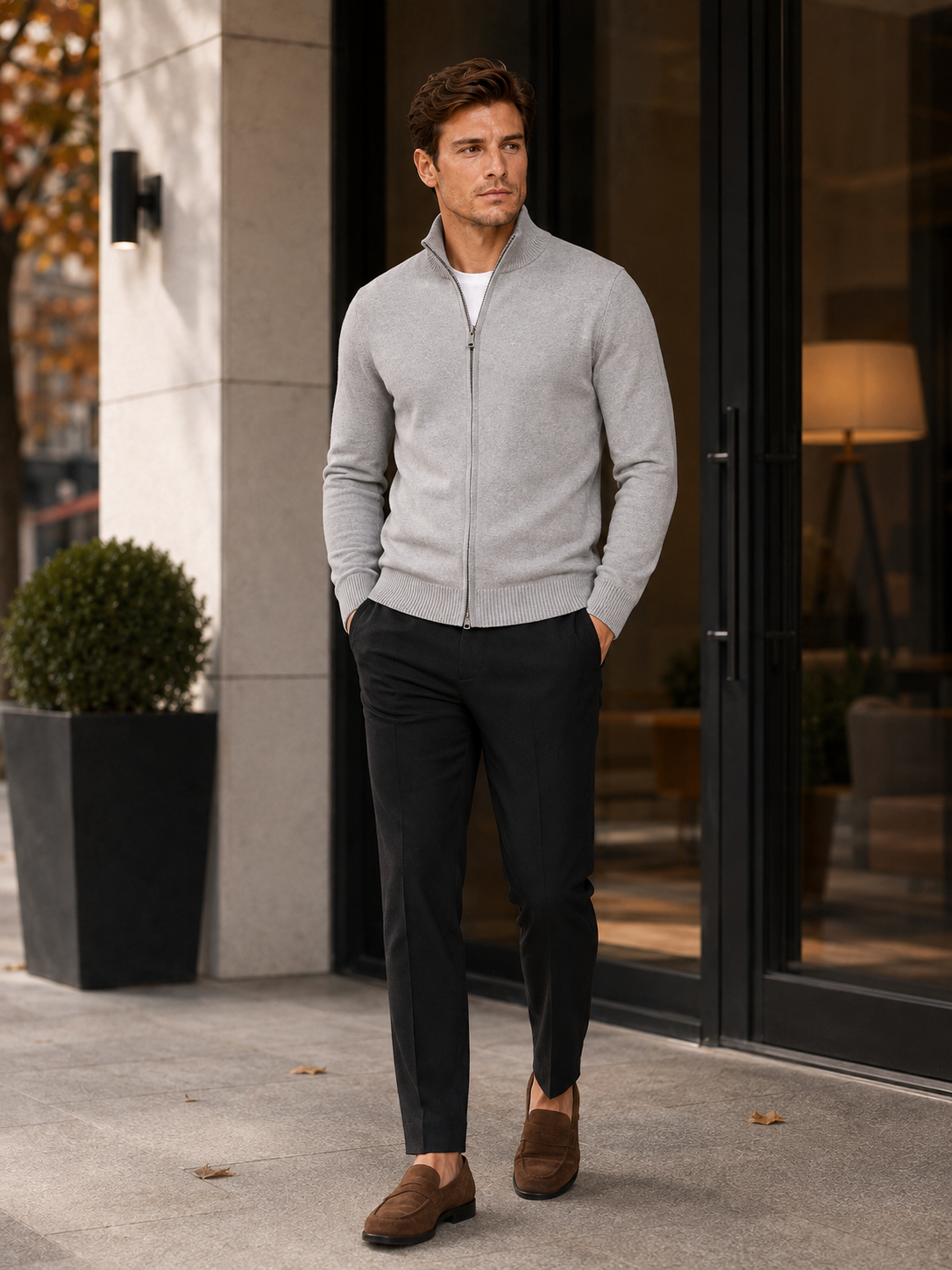 Man wearing a light gray full zip knit cardigan sweater in a business casual fall winter outfit for everyday wear