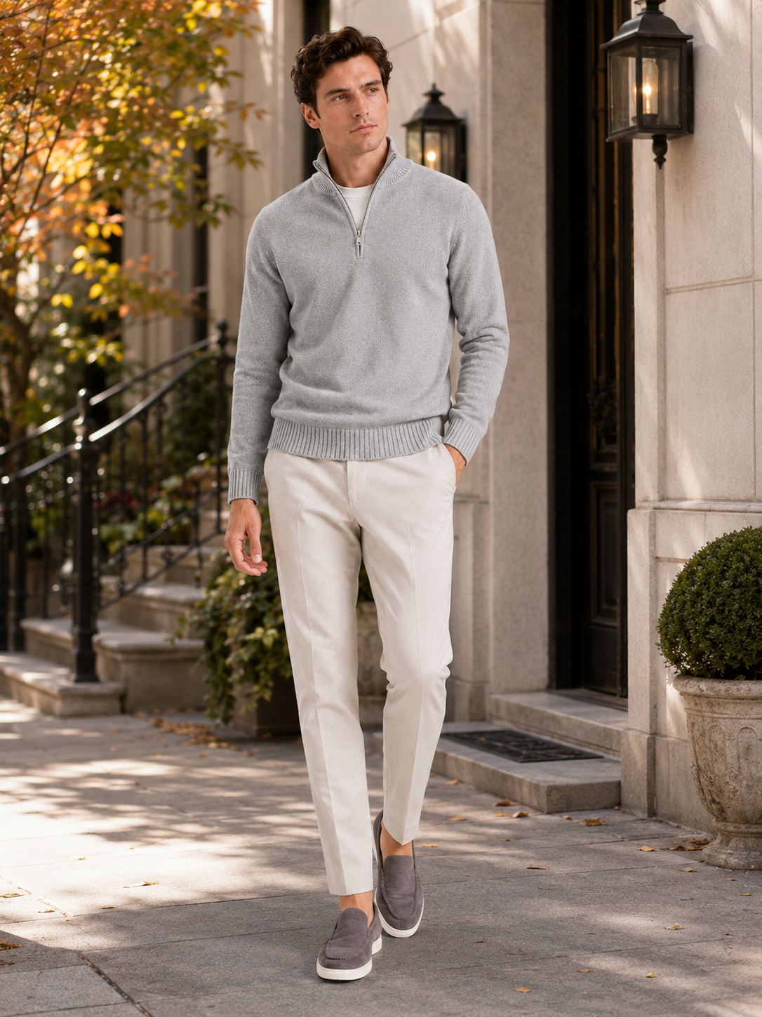 Man styling light gray half zip sweater in a clean fall lifestyle outfit
