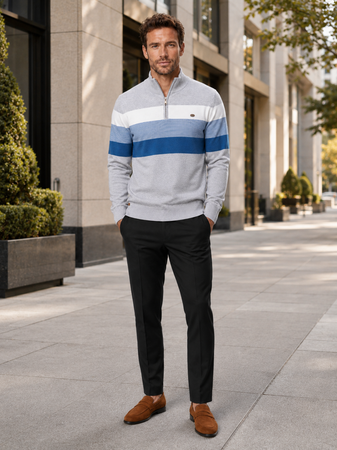 Man wearing a light gray patchwork cotton quarter zip sweater in a clean everyday winter outfit