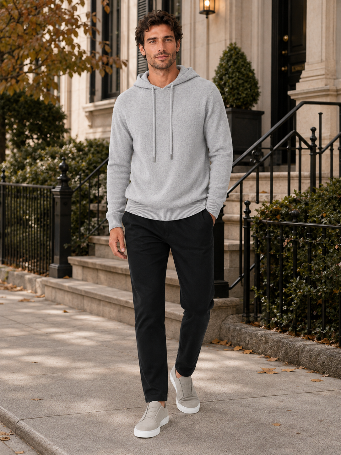 Man wearing a light gray wool hoodie sweater in a casual fall winter outfit for everyday wear