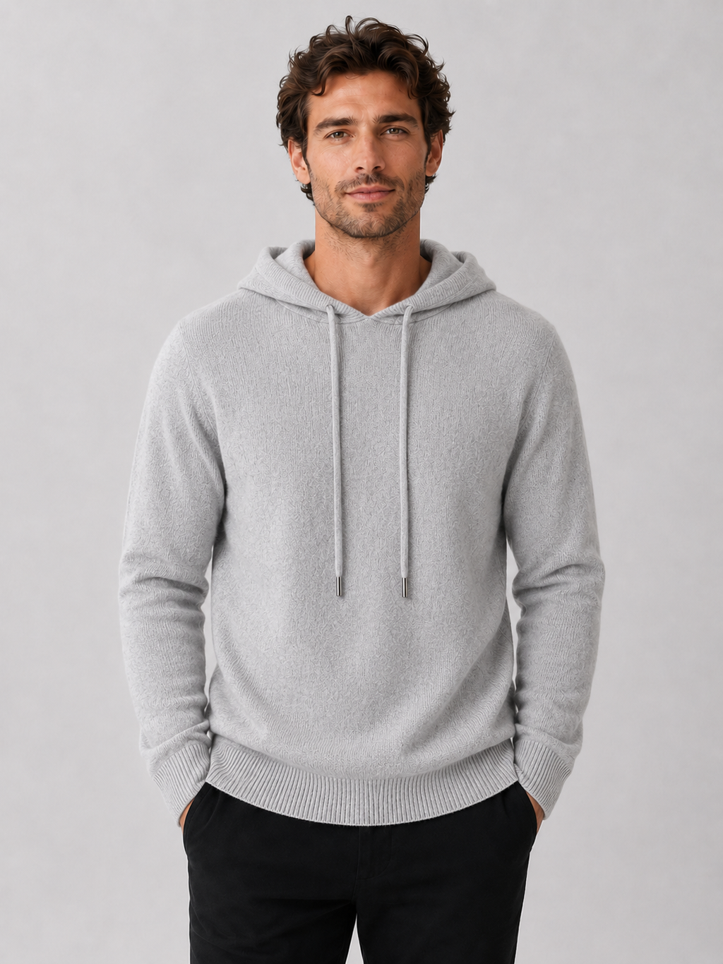 Front view of a man wearing a light gray wool hoodie sweater with a soft knit design, attached hood, and long sleeves