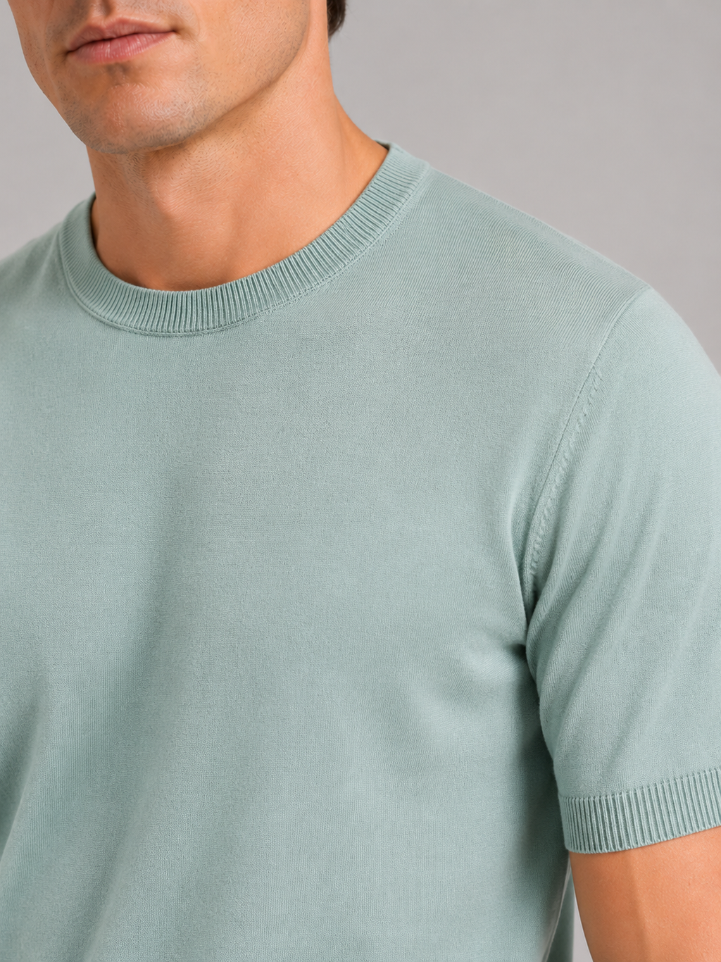 Close up of mint green merino wool knit t shirt showing soft breathable texture and crew neck detail