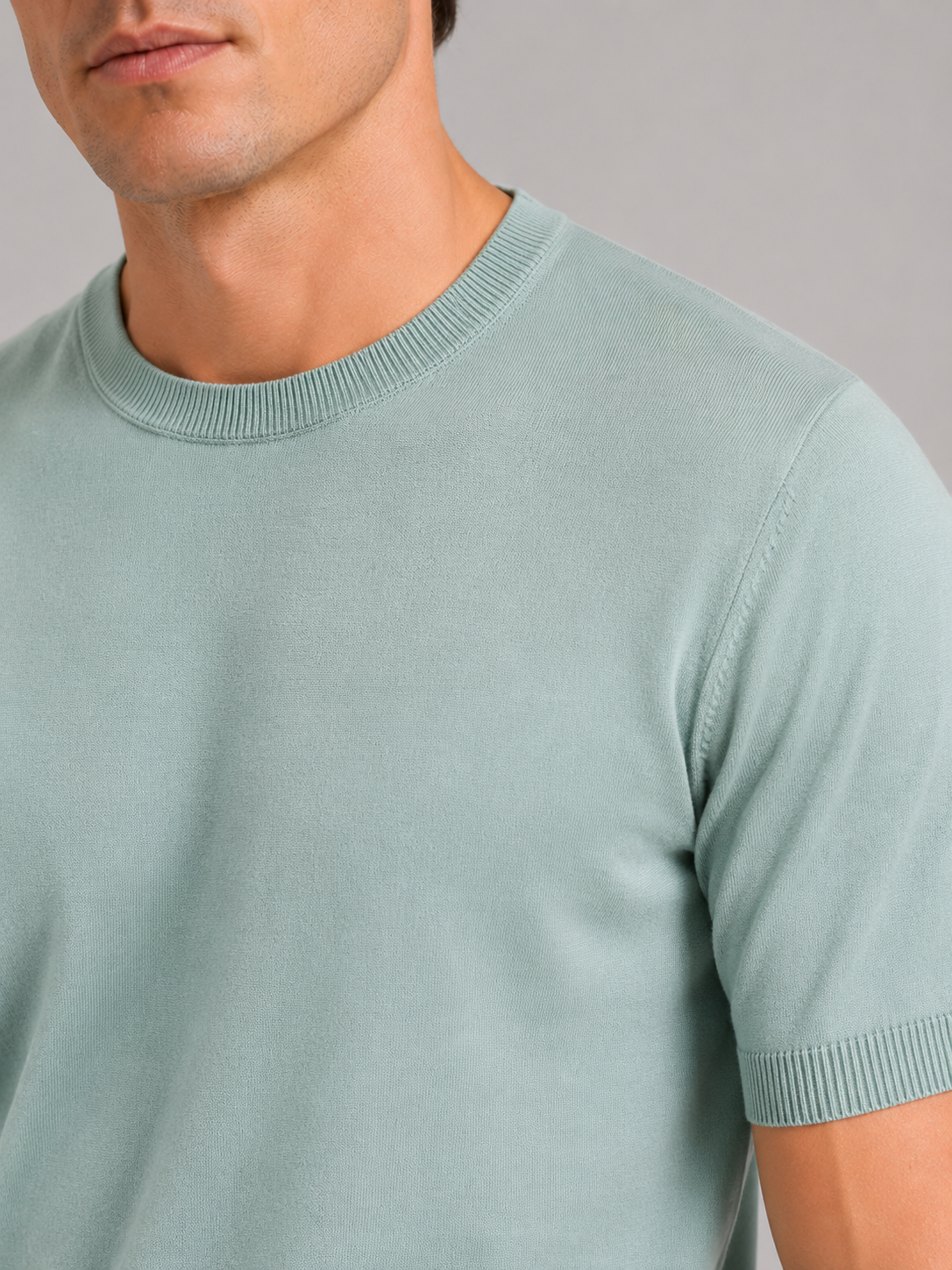 Close up of mint green merino wool knit t shirt showing soft breathable texture and crew neck detail