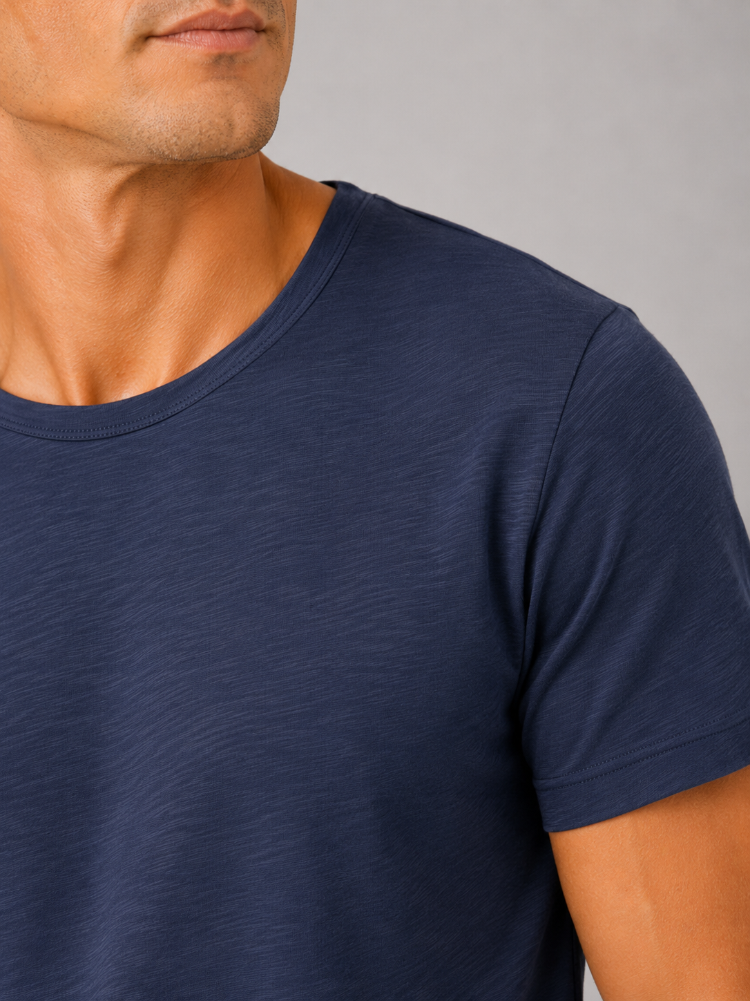 Close up of navy cotton t shirt showing soft breathable fabric and clean crew neck detail