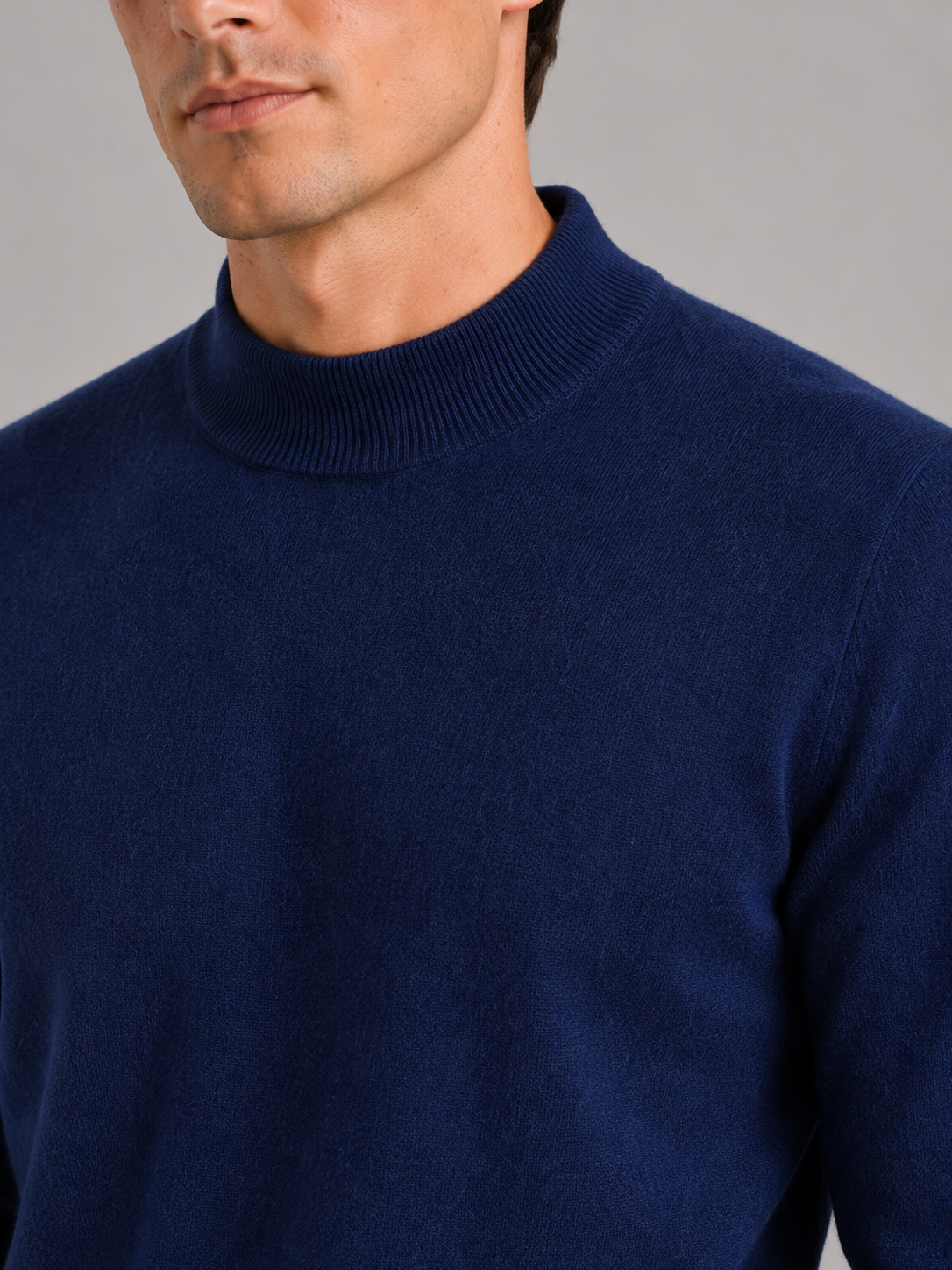 Close up of navy wool mock neck sweater showing soft premium knit texture and refined collar detail