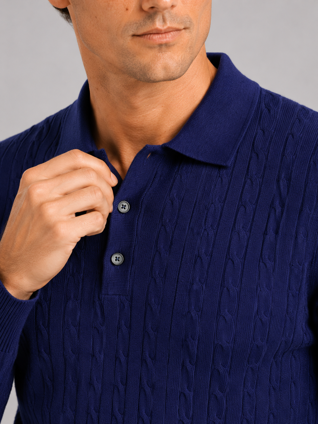 Close up of navy cable knit polo showing soft textured fabric and refined collar detail