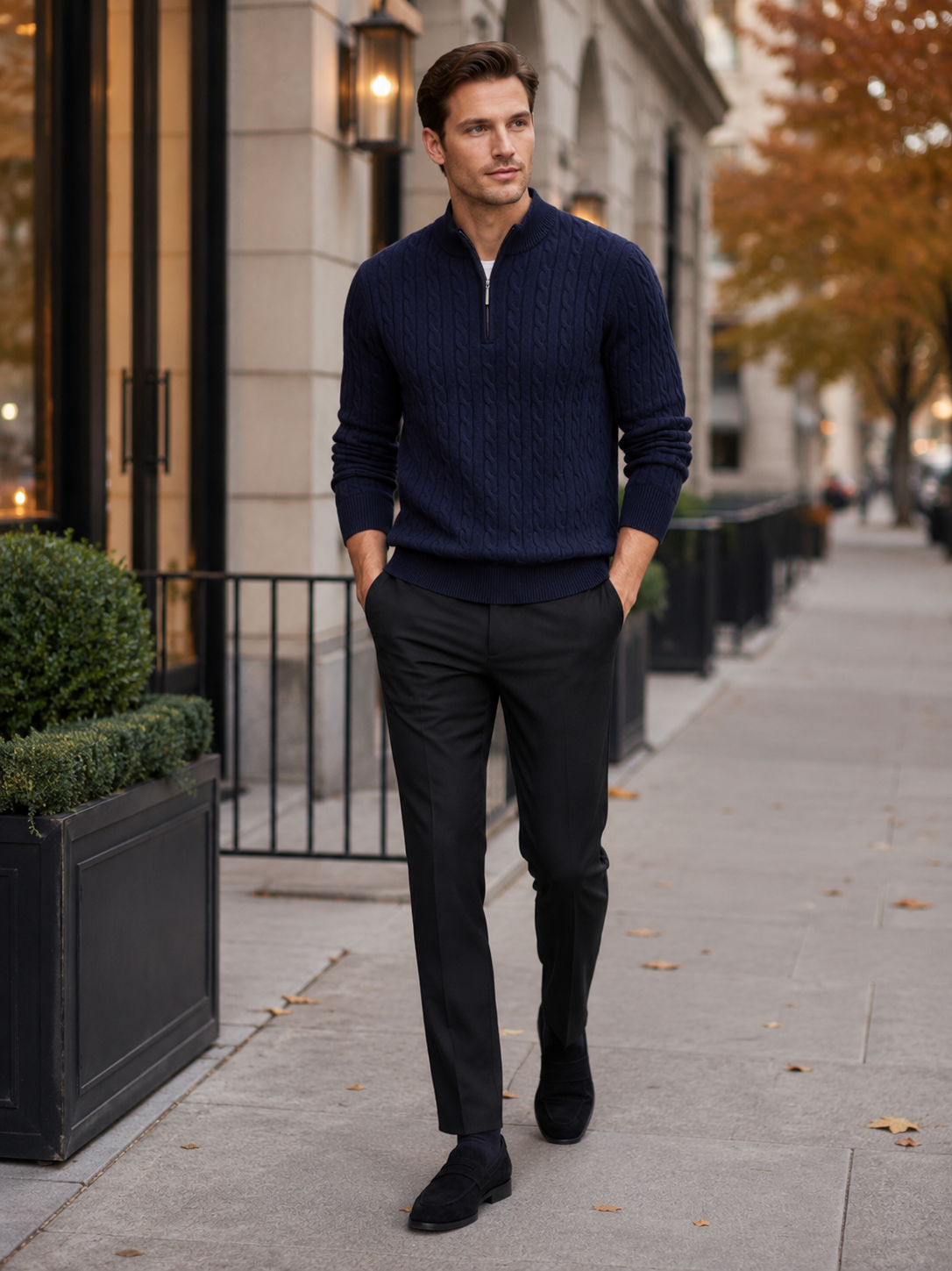 Man styling navy cable knit quarter zip sweater in a refined fall winter everyday outfit