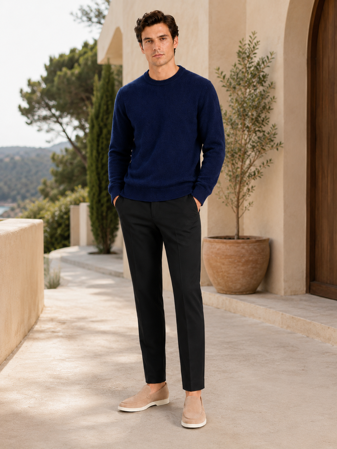 Man styling navy crewneck sweater in a refined everyday fall winter lifestyle outfit