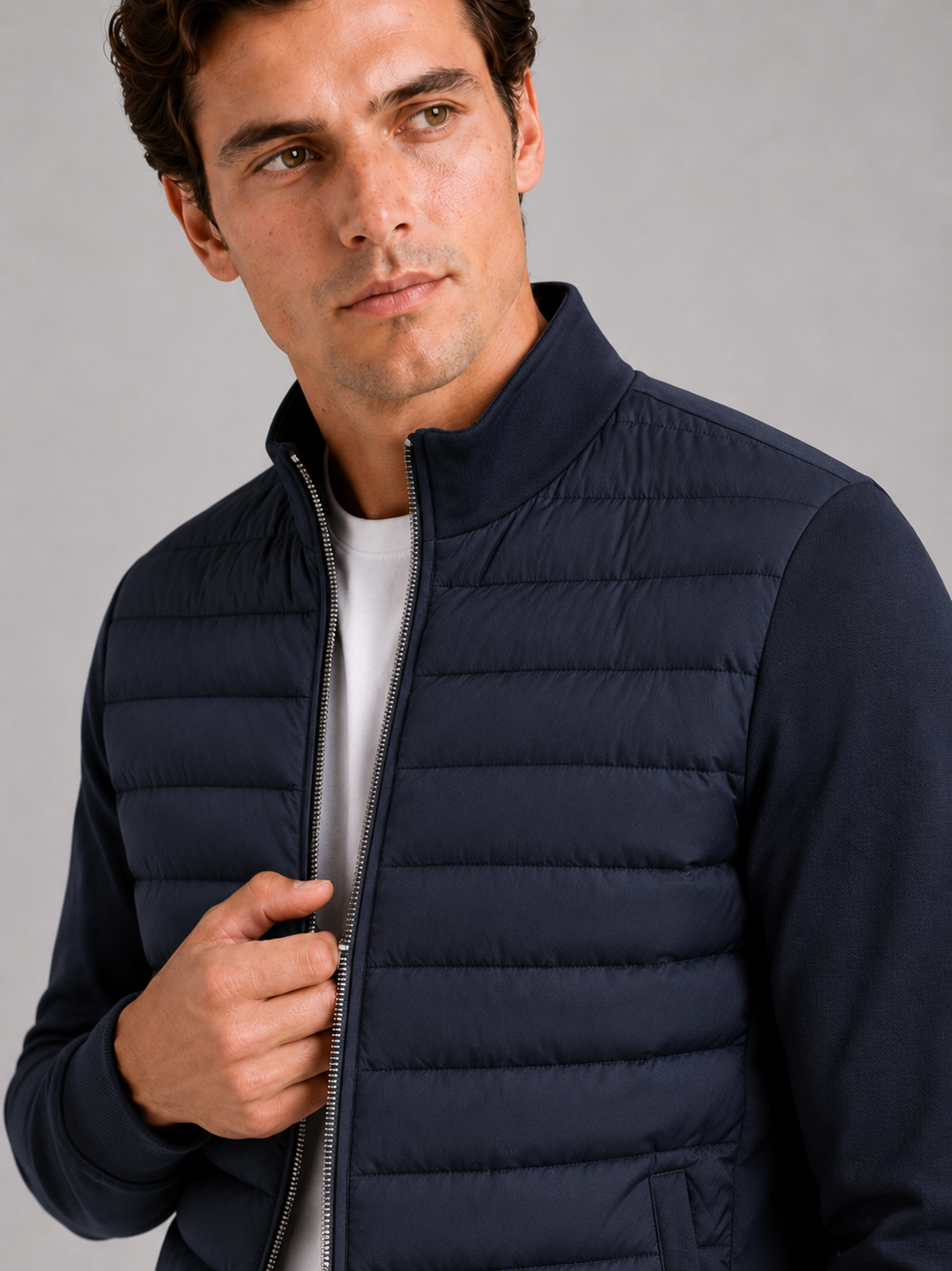 Close up of navy down jacket showing smooth padded fabric and stand collar detail