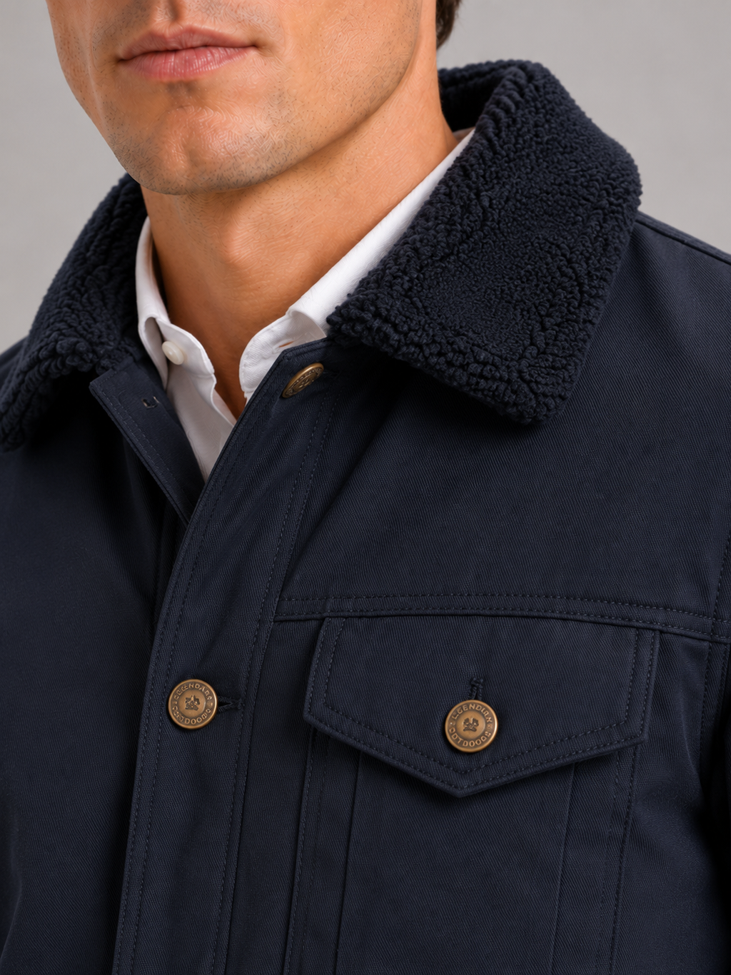 Close up of navy winter jacket showing soft fur collar and insulated fleece lined construction