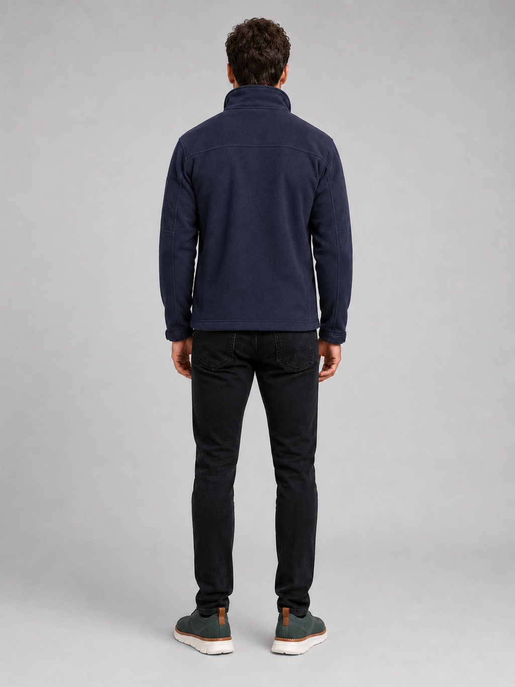Back view of a man wearing a navy fleece jacket showing the warm fleece construction, long sleeves, and comfortable outdoor fit