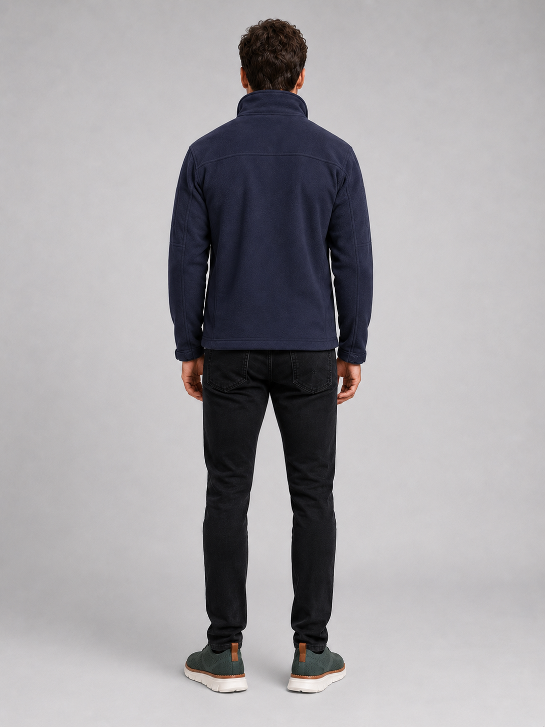 Back view of a man wearing a navy fleece jacket showing the warm fleece construction, long sleeves, and comfortable outdoor fit