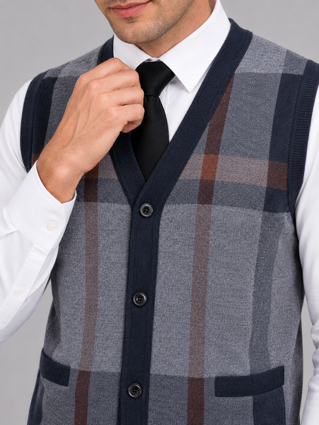 Close up of navy fleece sweater vest showing soft knit texture and button front detail