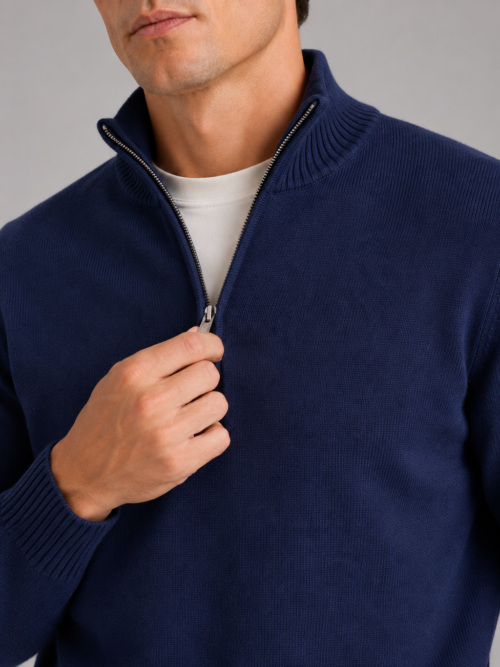 Close up of navy half zip sweater showing soft knit texture and refined zipper detail