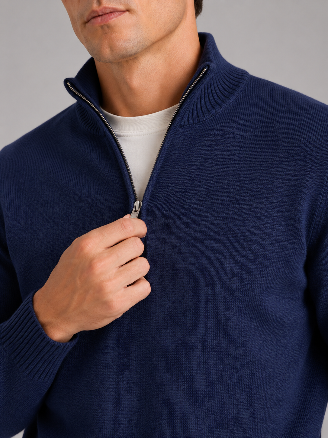 Close up of navy half zip sweater showing soft knit texture and refined zipper detail