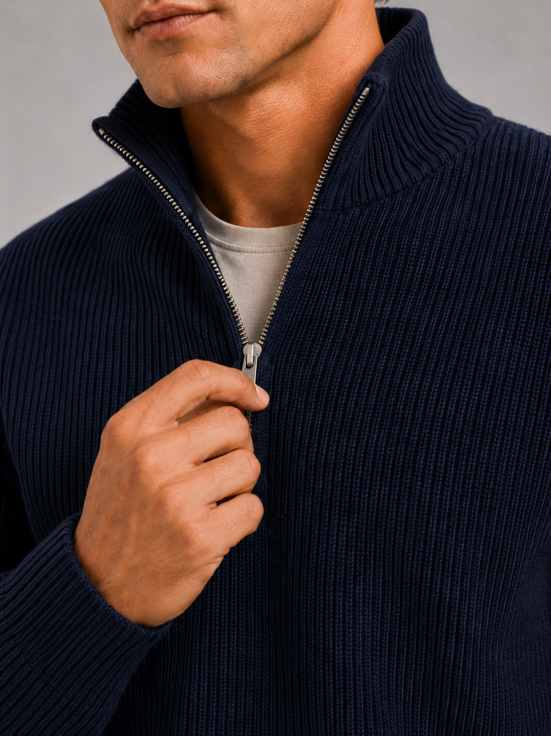 Close up of navy half zip sweater showing thick knit texture and refined zipper detail