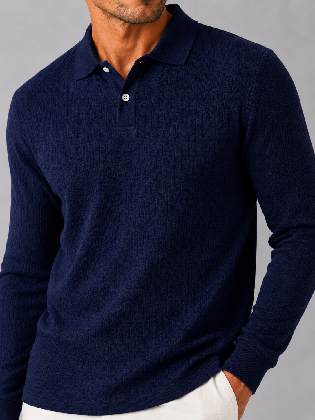 Close up of navy knit polo shirt showing soft textured fabric and refined collar detail