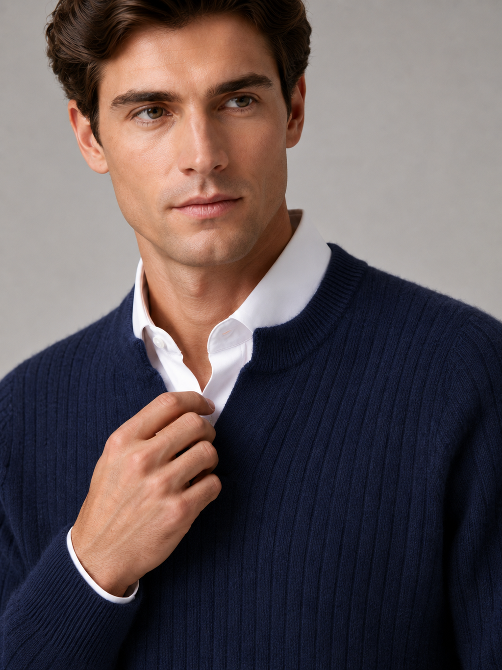 Close up of navy merino wool sweater showing soft fine knit texture and refined open collar detail