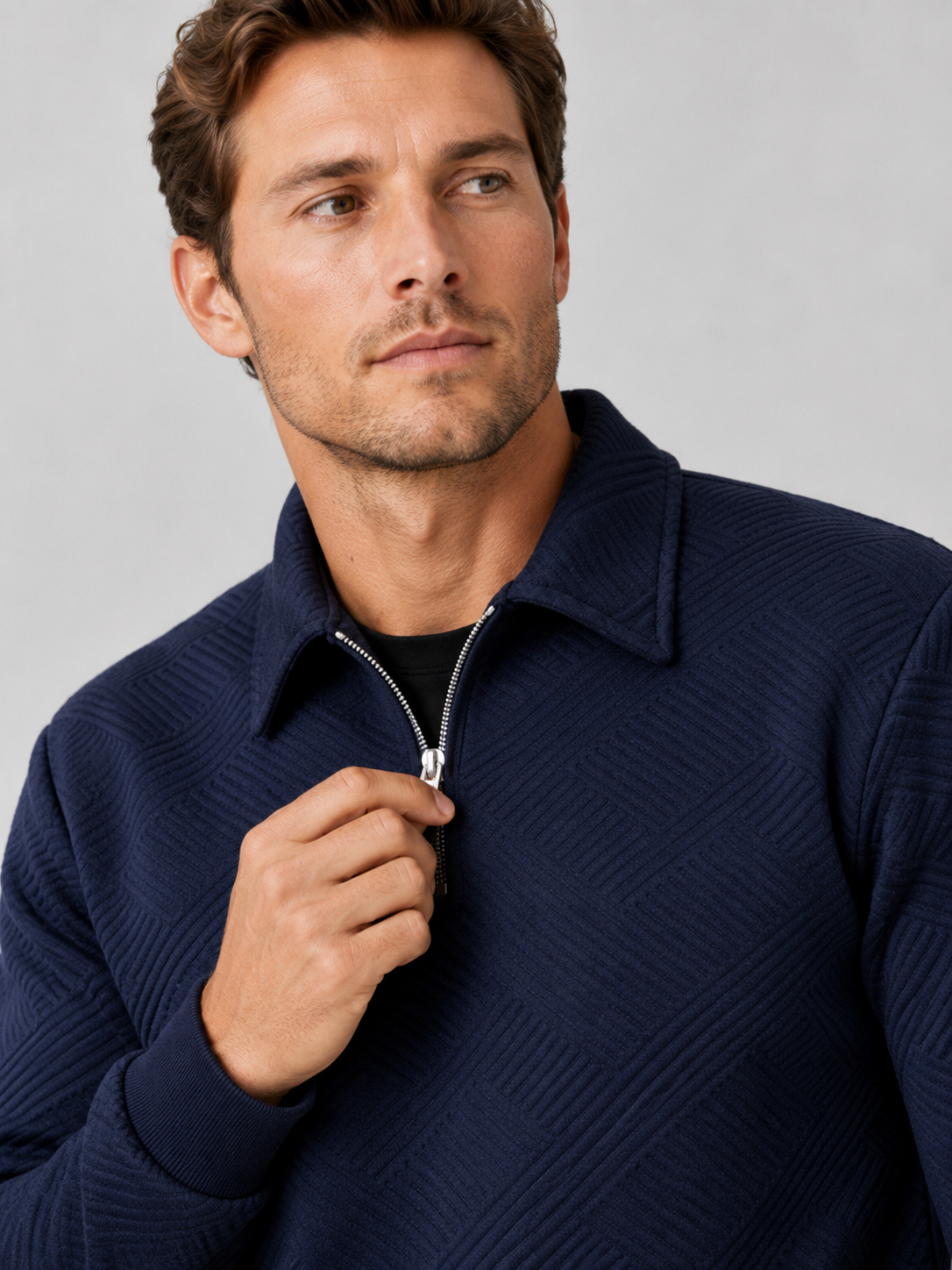 Close up of navy quarter zip sweater showing soft knit texture and refined zipper collar detail