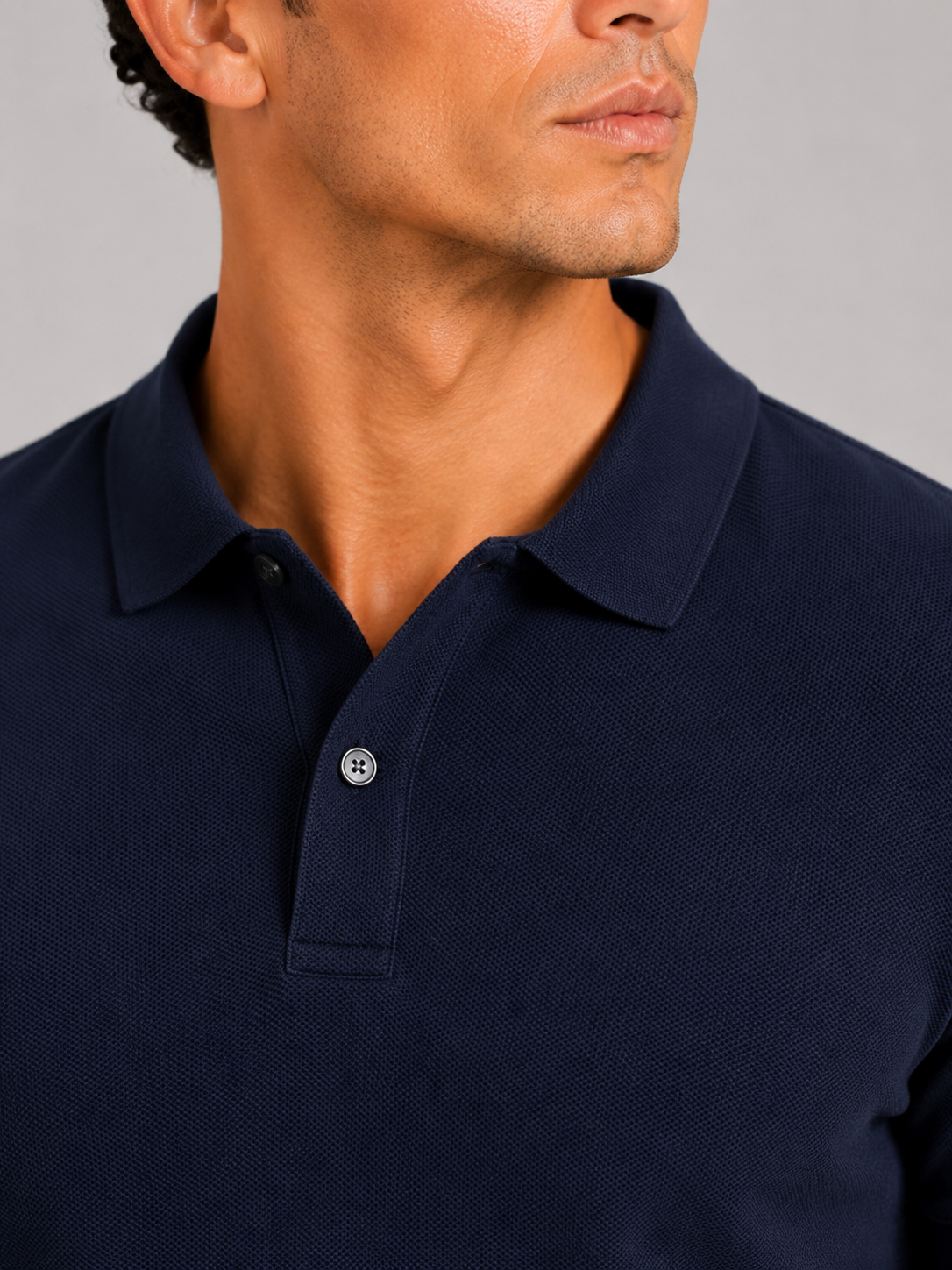 Close up of navy polo shirt showing smooth silk touch fabric and refined collar detail