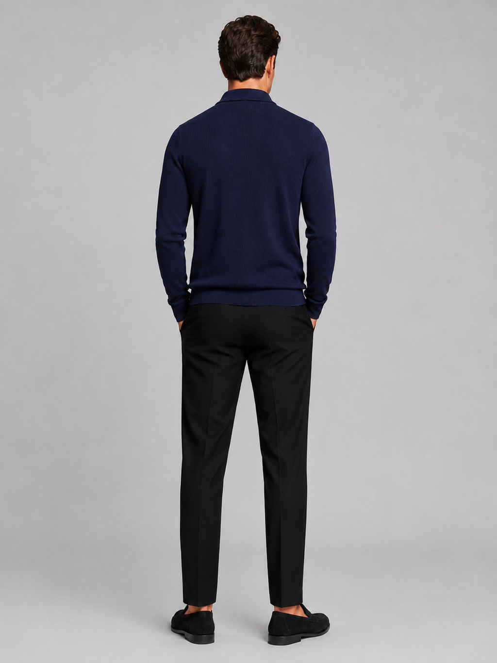 Back view of a man wearing a navy quarter zip polo showing the long sleeves, structured collar, and comfortable fall fit