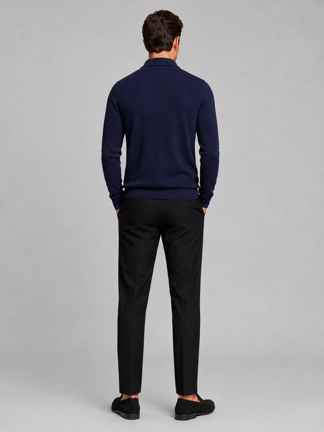 Back view of a man wearing a navy quarter zip polo showing the long sleeves, structured collar, and comfortable fall fit