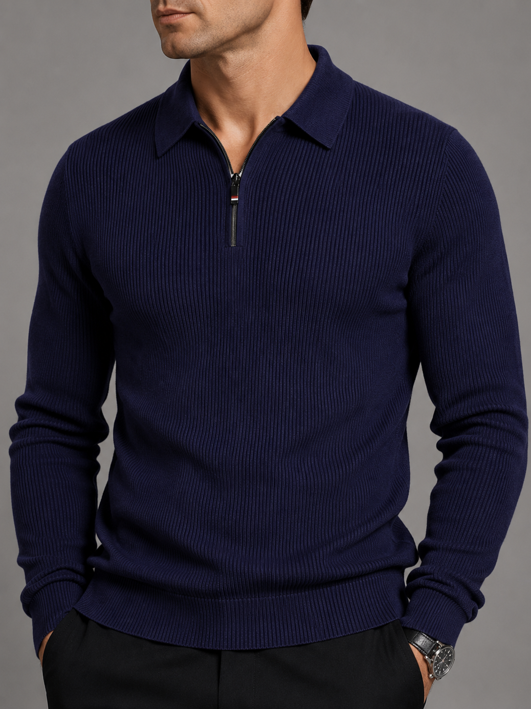 Close-up of a navy quarter zip long sleeve polo showing the zipper closure, lapel collar, soft fabric texture, cuffs, hem, and stitching