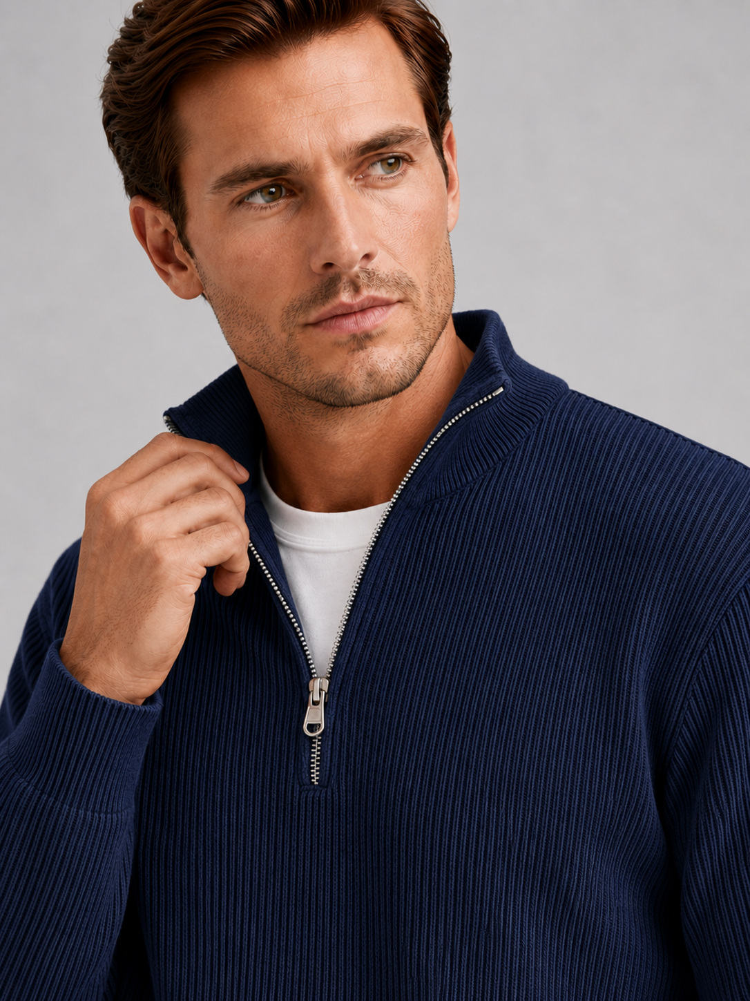 Close up of navy quarter zip sweater showing ribbed knit texture, stand collar, and zipper detail