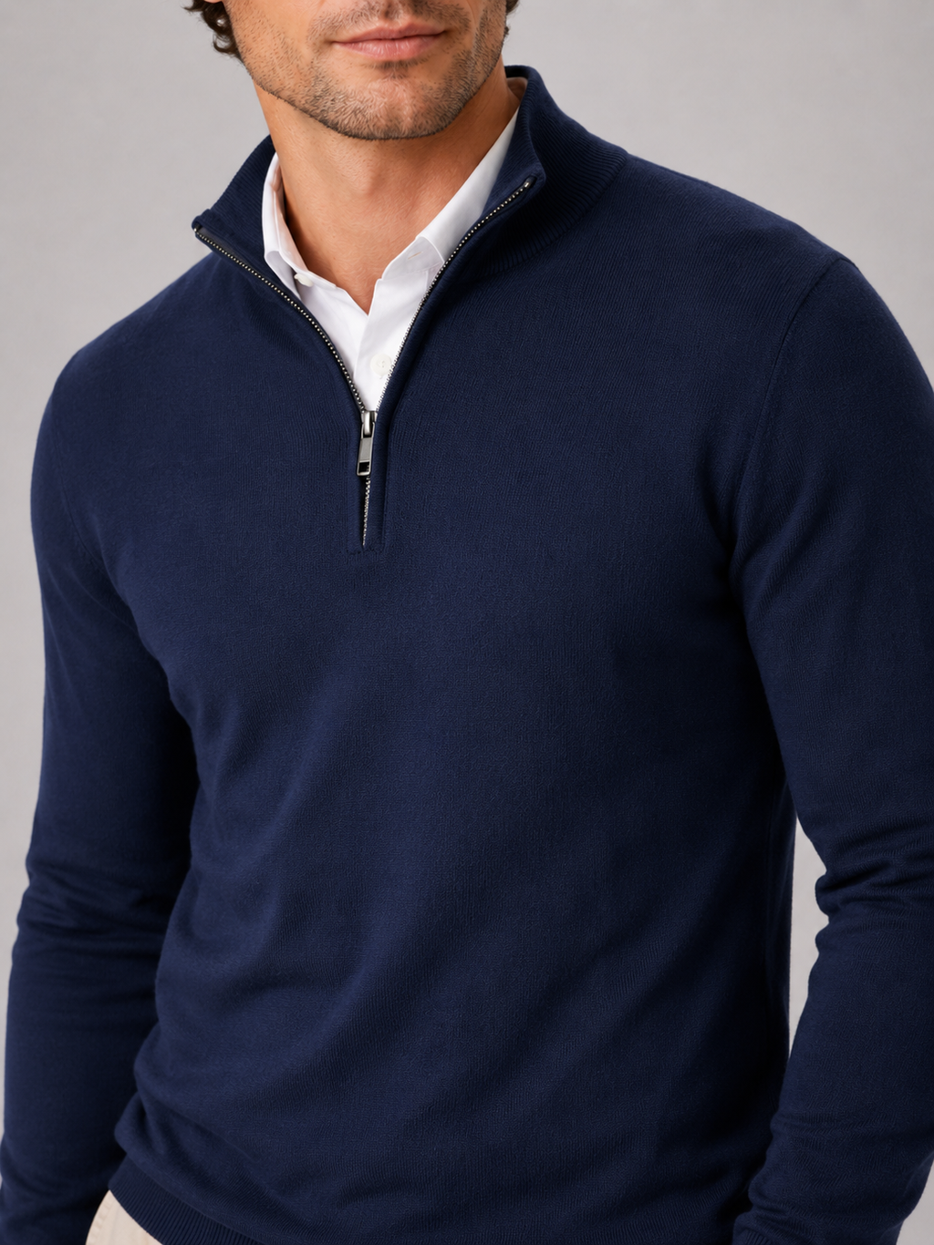 Close up of navy quarter zip sweater showing soft knit texture and mock neck zipper detail