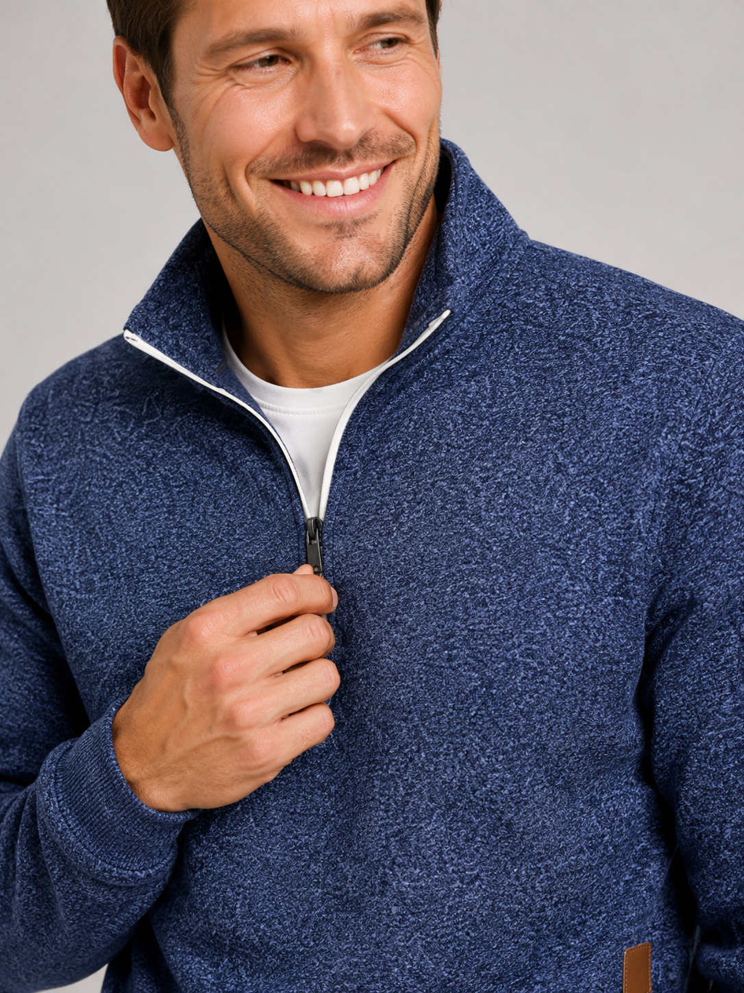Close up of navy quarter zip sweater showing soft knit texture and stand collar zipper detail
