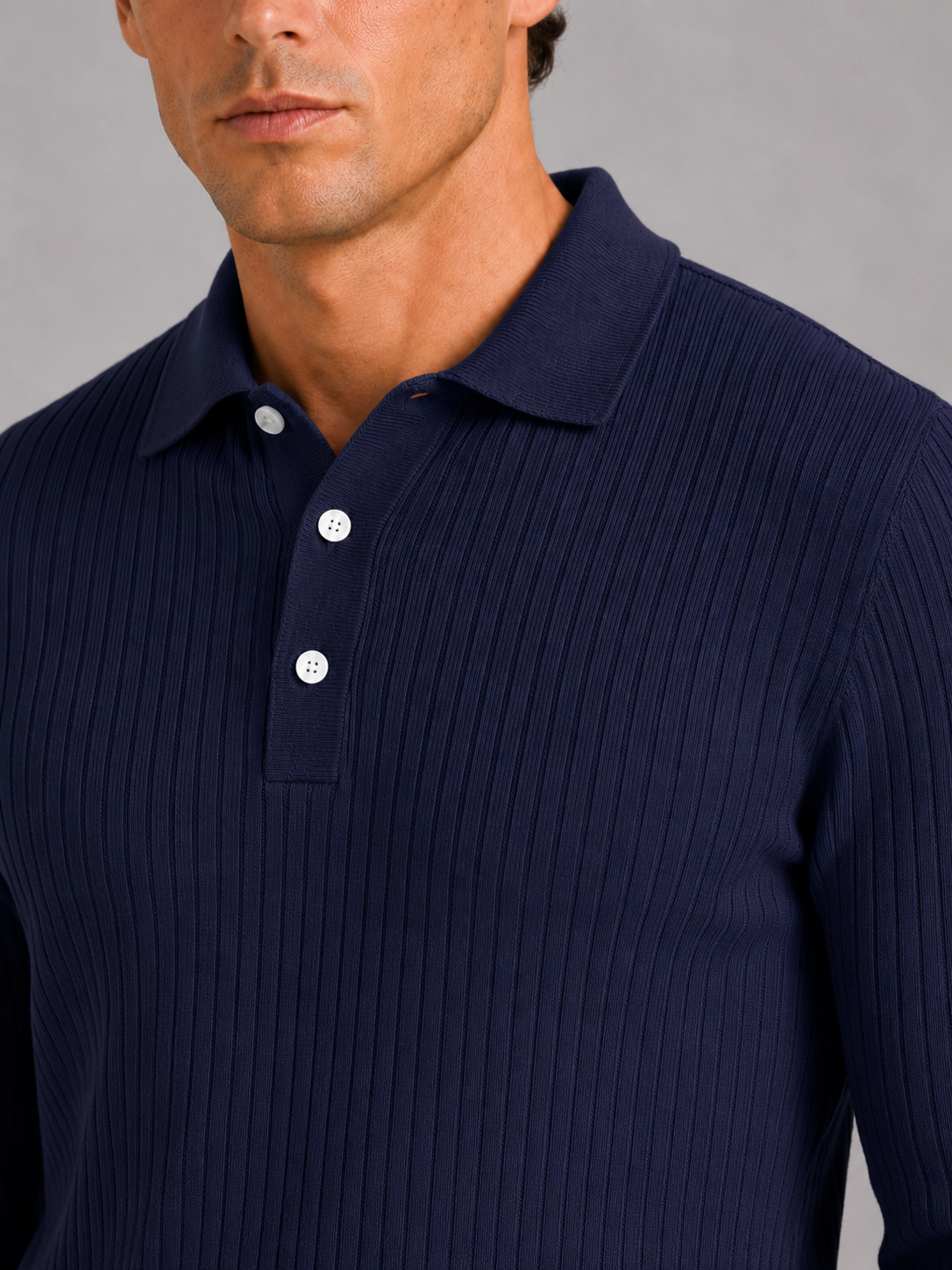 Close up of navy ribbed polo shirt showing soft textured fabric and refined collar detail