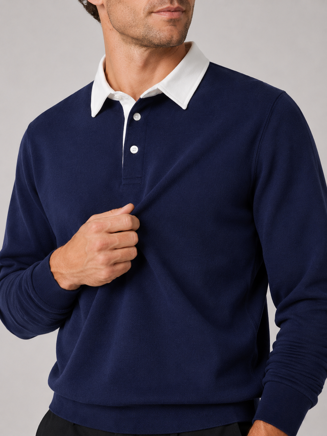 Close up of navy rugby polo shirt showing soft knit fabric and classic collar detail