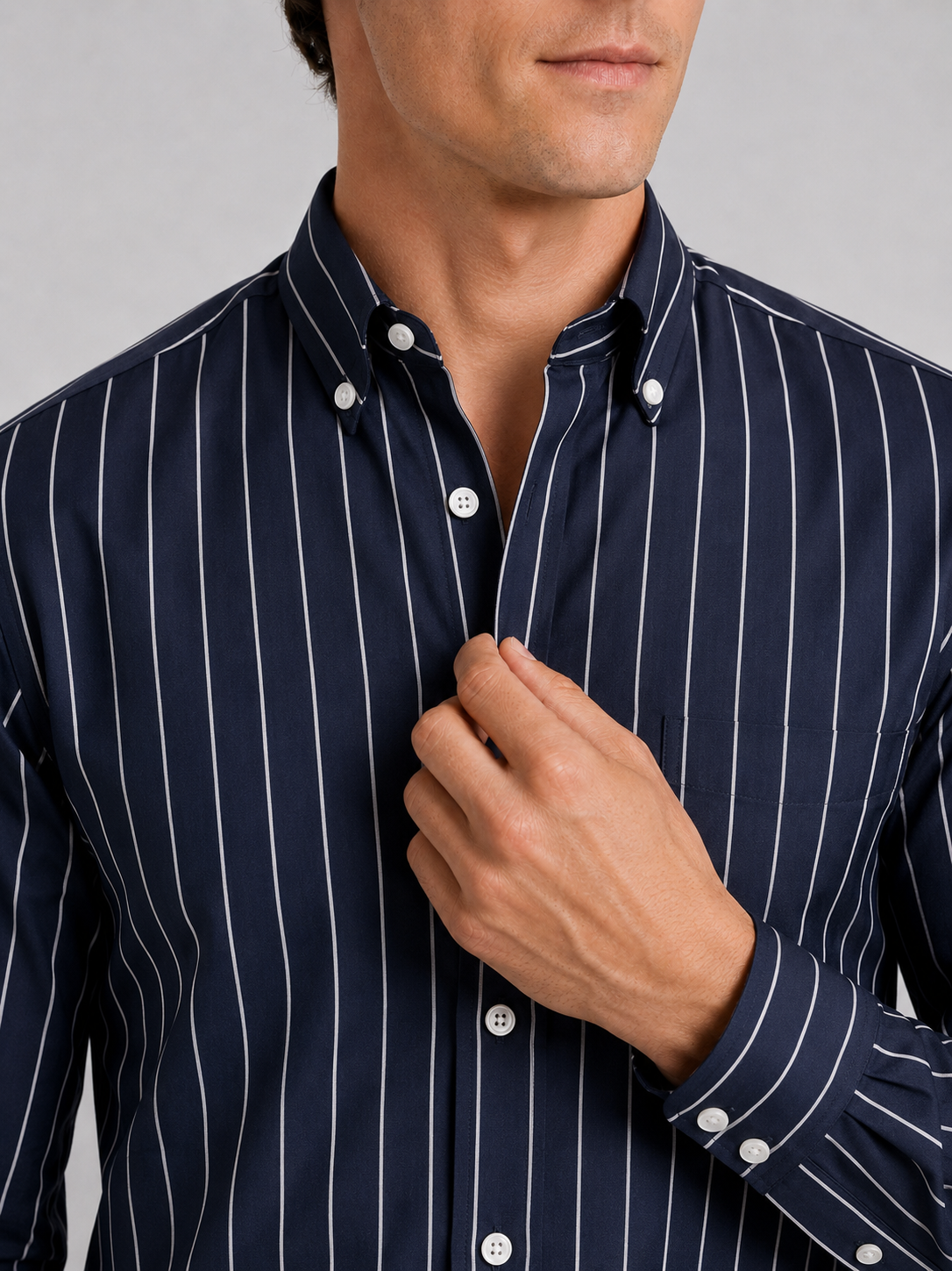 Close up of navy striped dress shirt showing crisp fabric and refined collar detail
