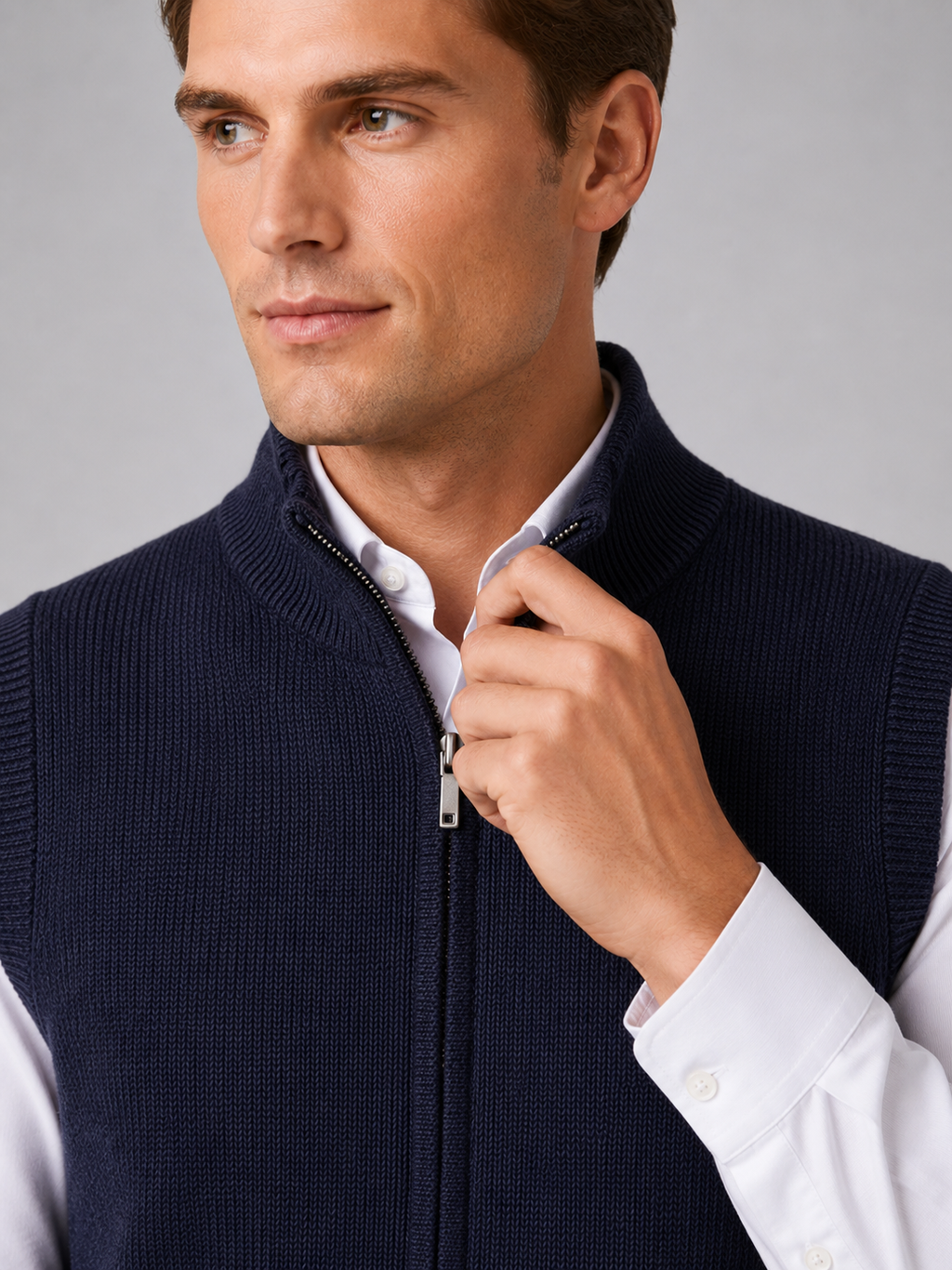 Close up of navy full zip sweater vest showing soft knit texture and mock neck zipper detail