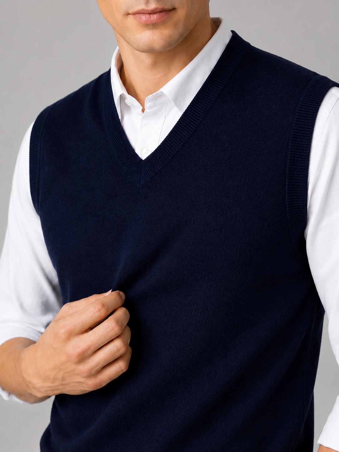Close up of navy sweater vest showing soft knit texture and classic v neck detail