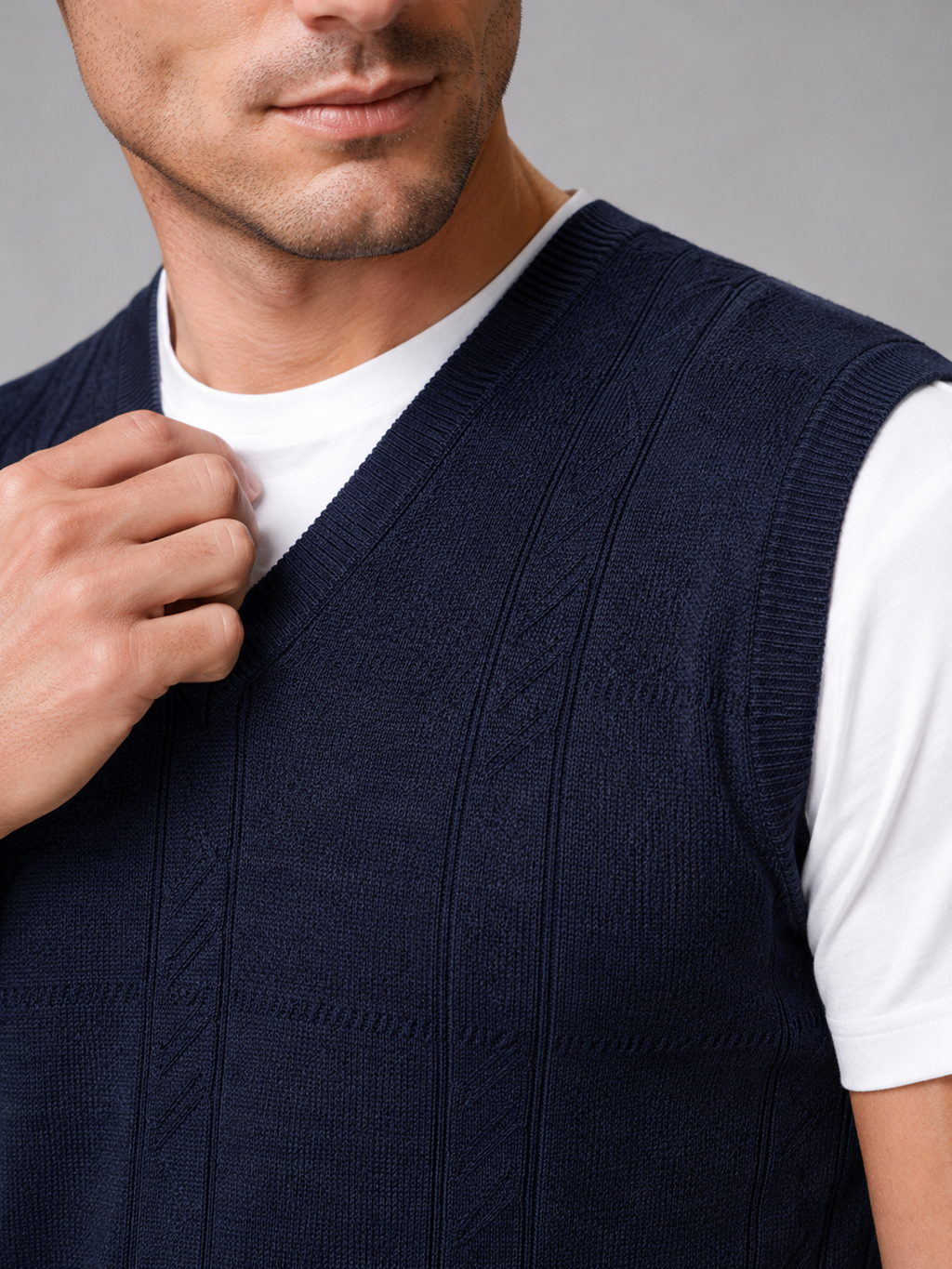 Close up of navy sweater vest showing soft knit texture and classic v neck detail