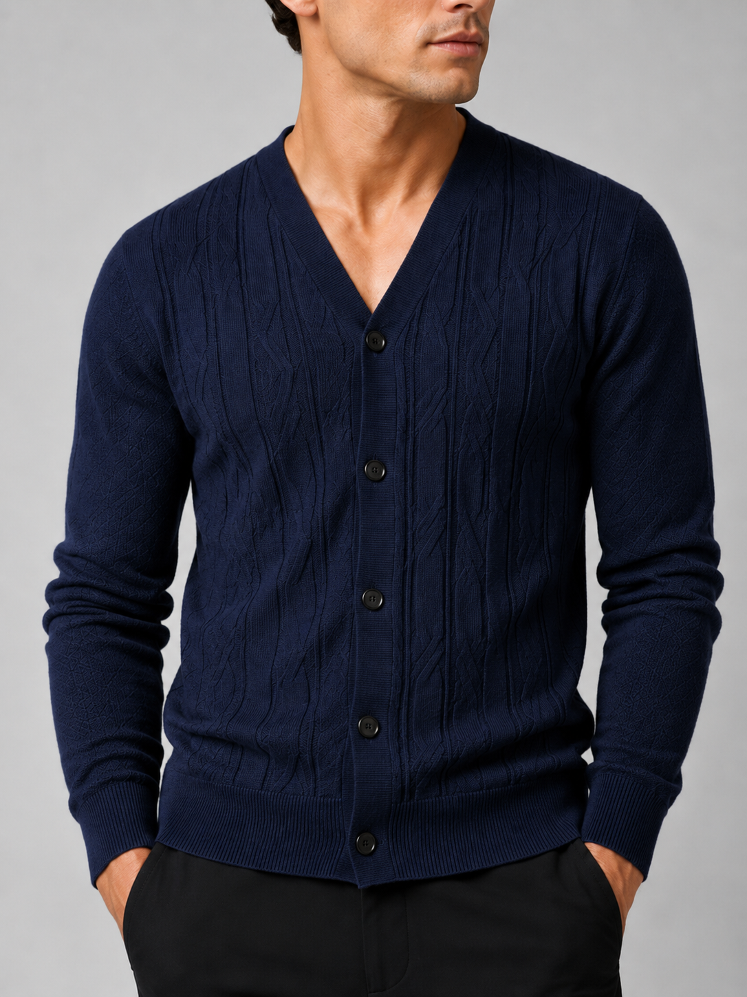 Close up of navy knit cardigan showing soft lightweight texture and refined button front detail