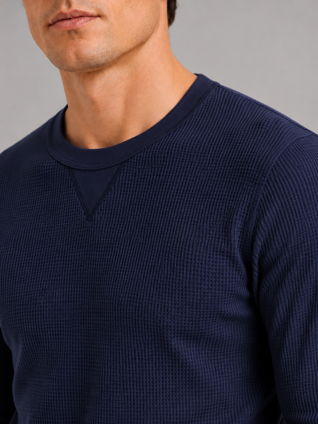 Close up of navy waffle knit shirt showing textured thermal fabric and soft knit detail