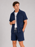 Men wearing navy corduroy button up shirt and shorts set summer vacation outfit beach style