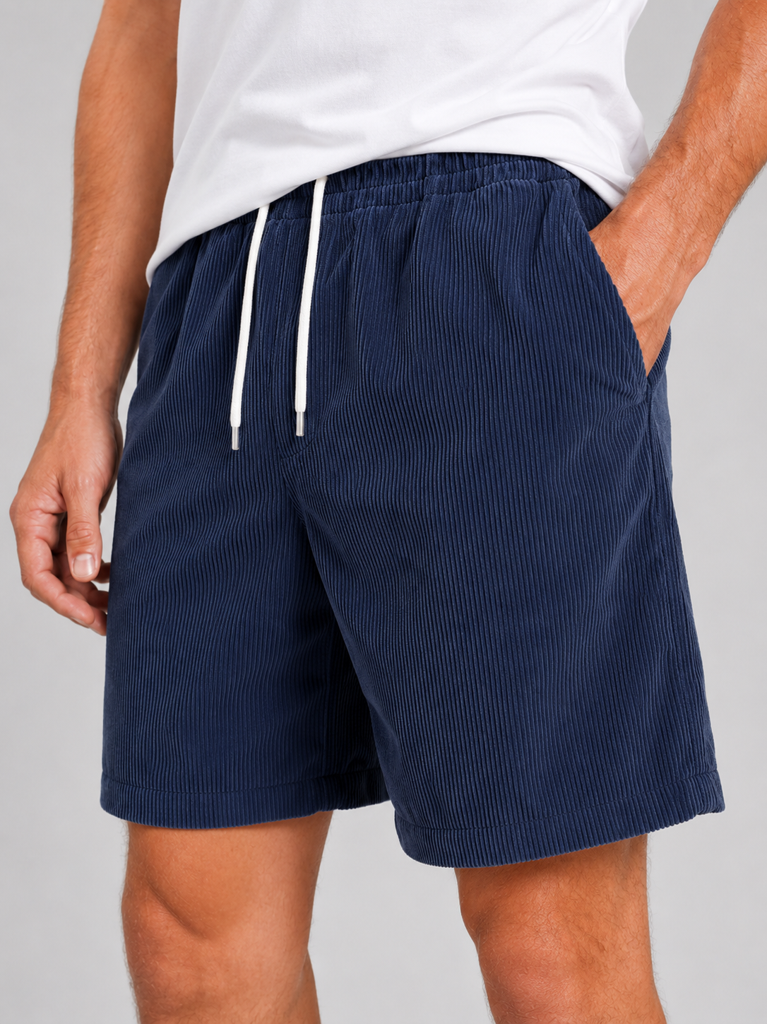Close up of navy corduroy shorts showing soft textured fabric and adjustable drawstring waistband