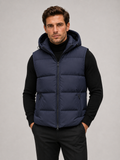 Man wearing a black hooded puffer vest in a casual fall winter outfit for outdoor and everyday wear