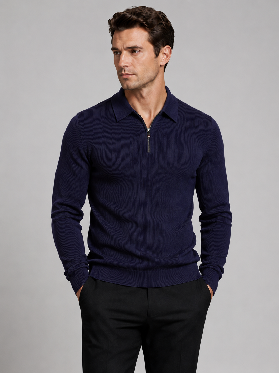 Front view of a man wearing a navy quarter zip long sleeve polo with a lapel collar and tailored business casual fit