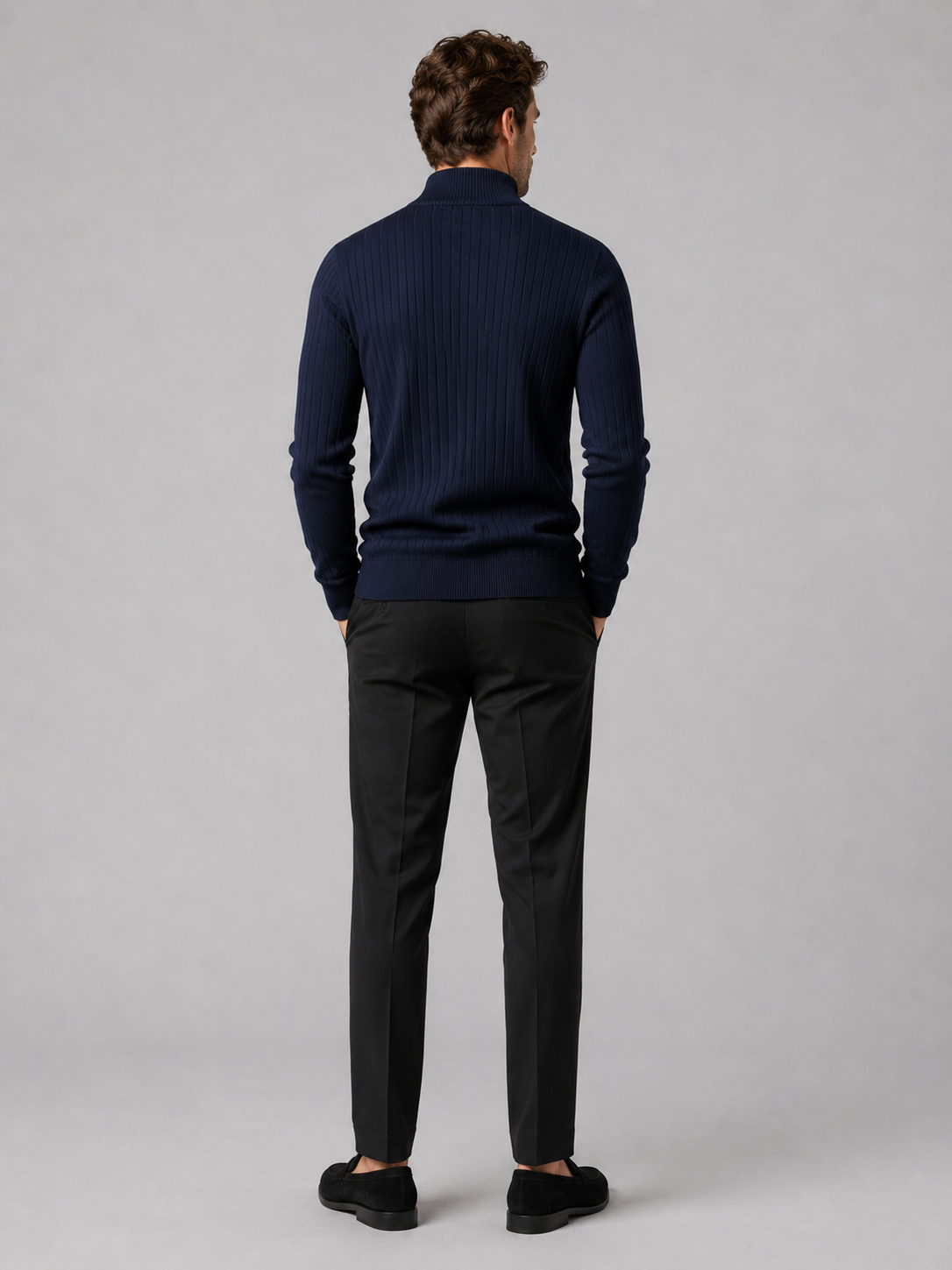 Back view of a man wearing a navy quarter zip sweater showing the long sleeves, clean knit construction, and comfortable fit