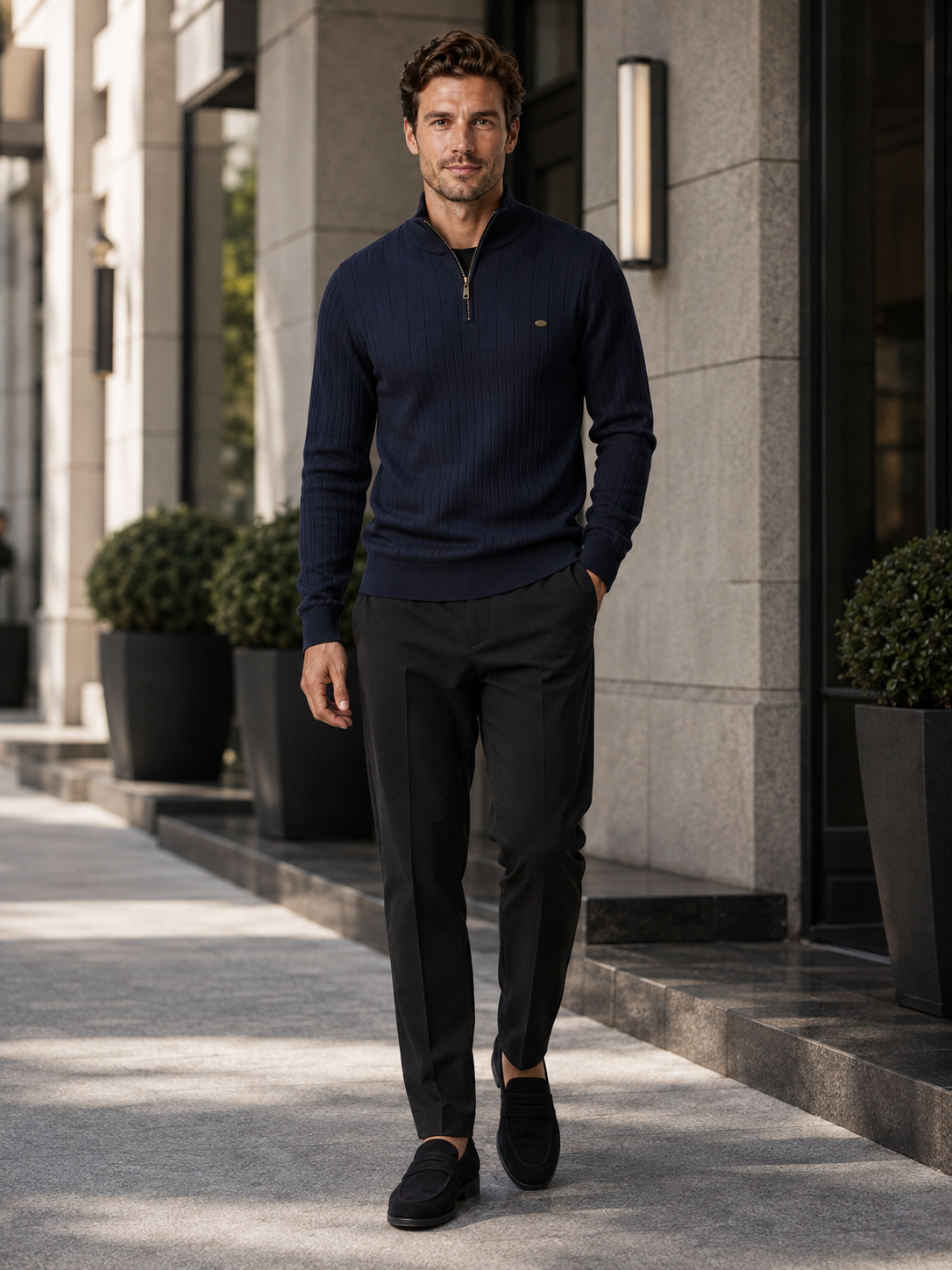 Man wearing a navy quarter zip cotton knit sweater in a business casual fall winter outfit for everyday wear