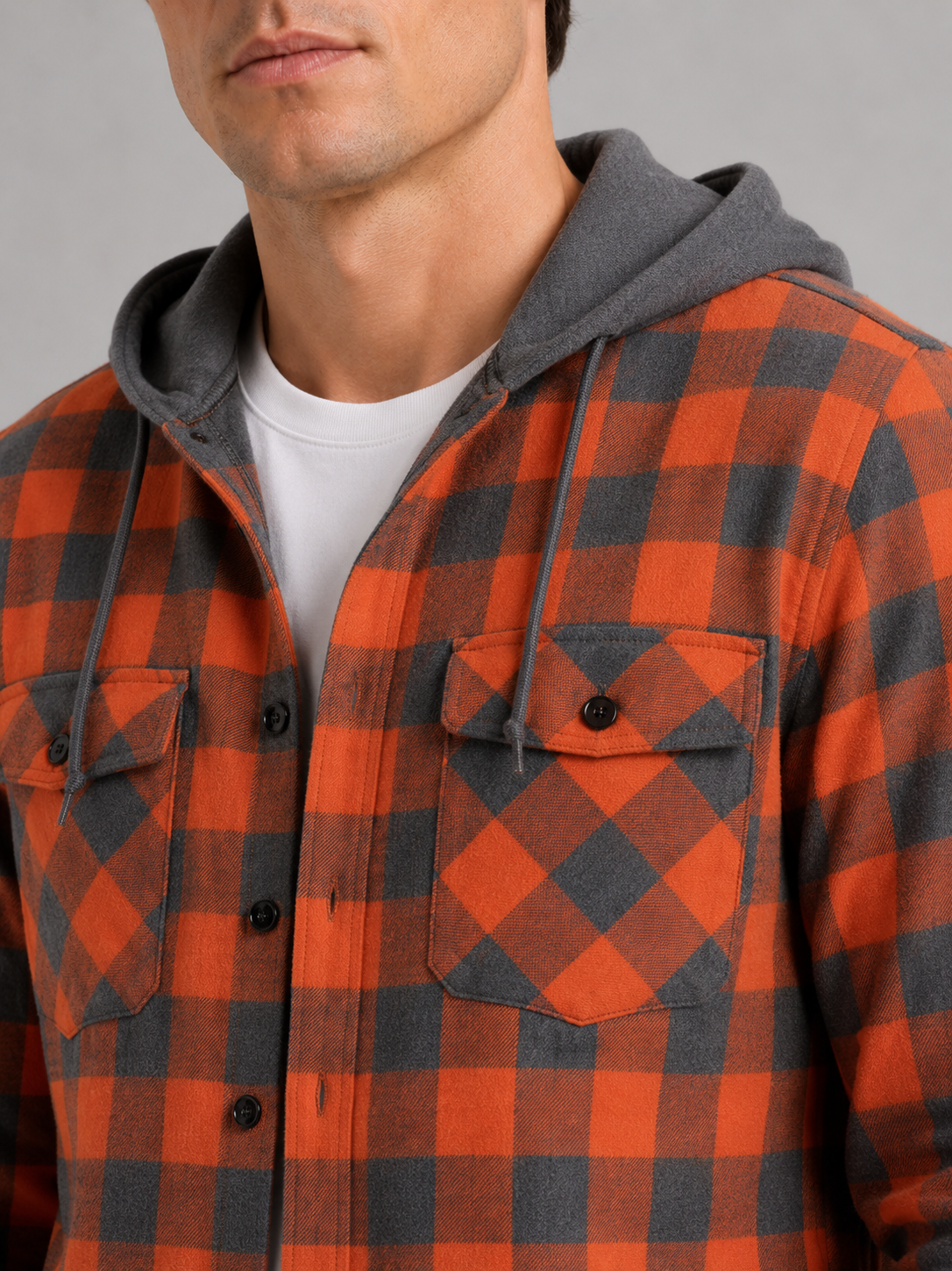 Close up of orange plaid flannel jacket showing soft brushed fabric and hood detail