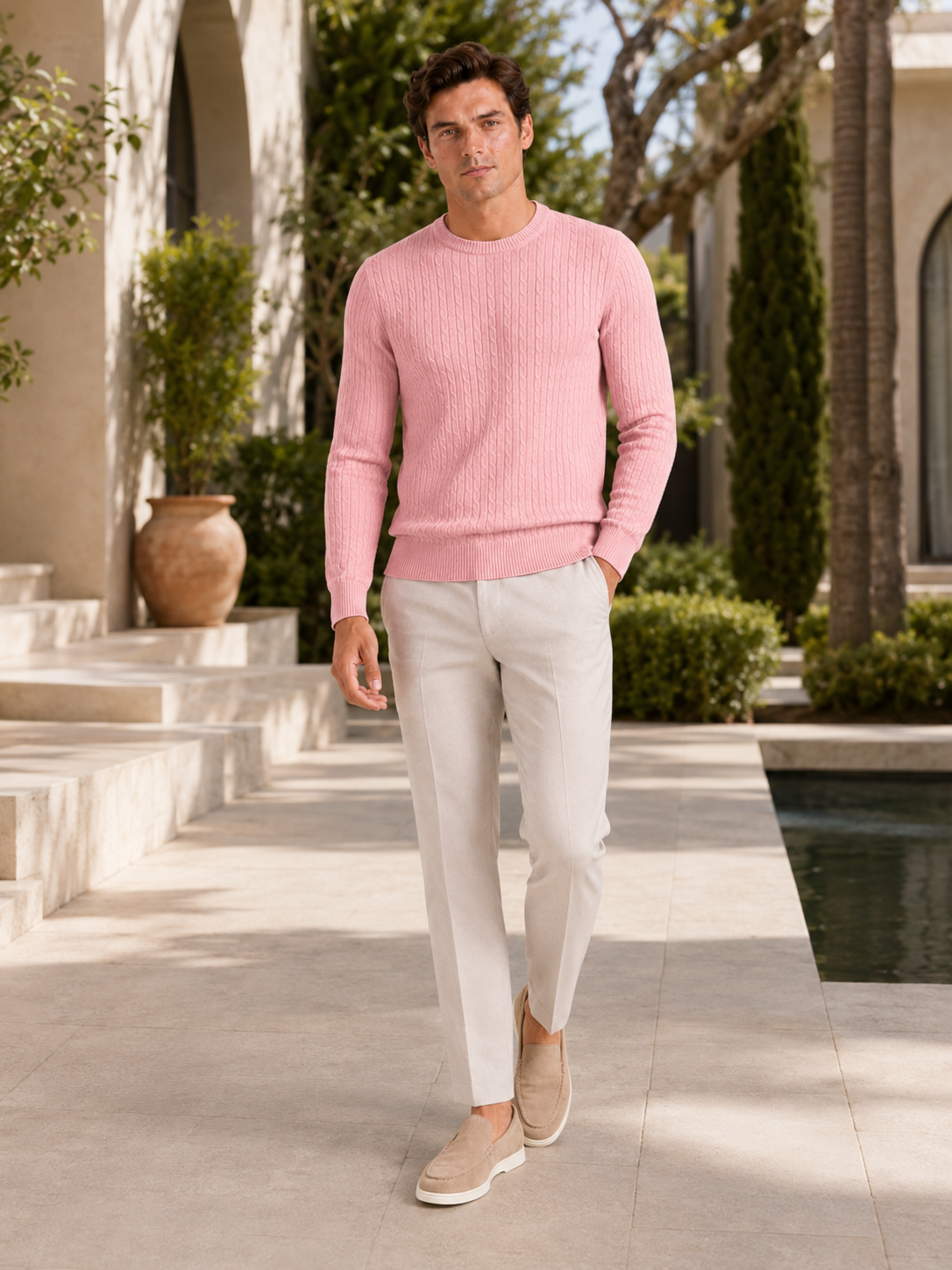 Man styling pink cable knit crew neck sweater in a fresh spring lifestyle outfit